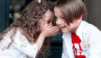 woman in white long sleeve shirt kissing girl in white long sleeve shirt