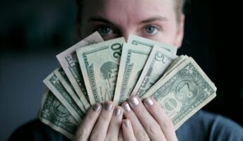 Young woman holding money.